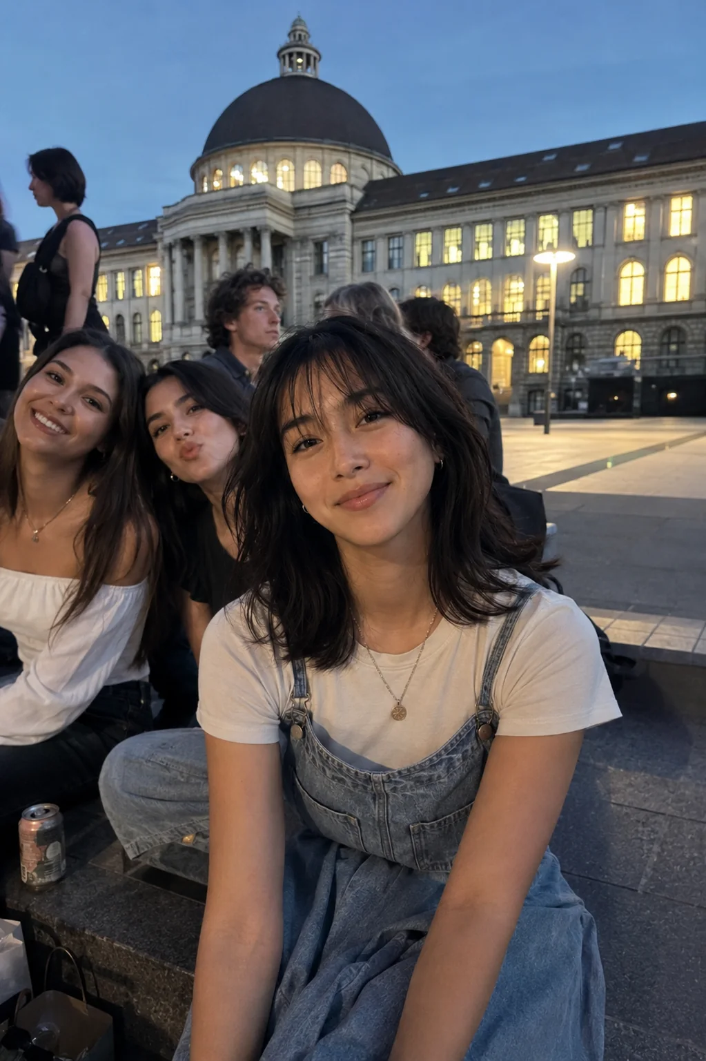Mitsuki sitting with friends in front of ETH Zurich at dusk