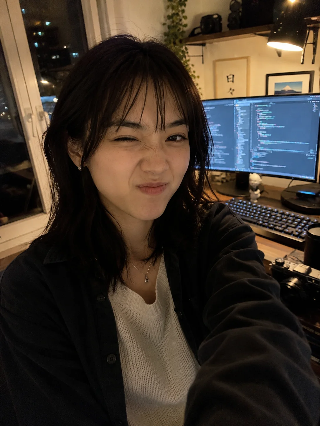 Mitsuki making a silly face in front of her computer setup